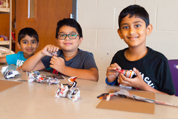 Kids at table making craft