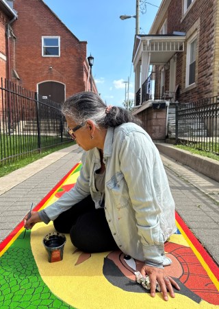 An artist painting a mural piece