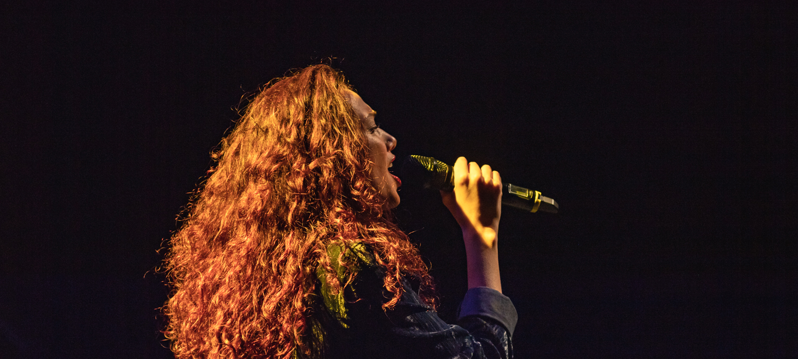 female performer singing on stage