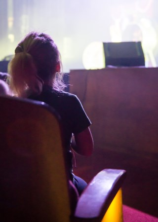 Small child sitting in seat watching live performance