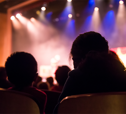 Audience members looking at the stage