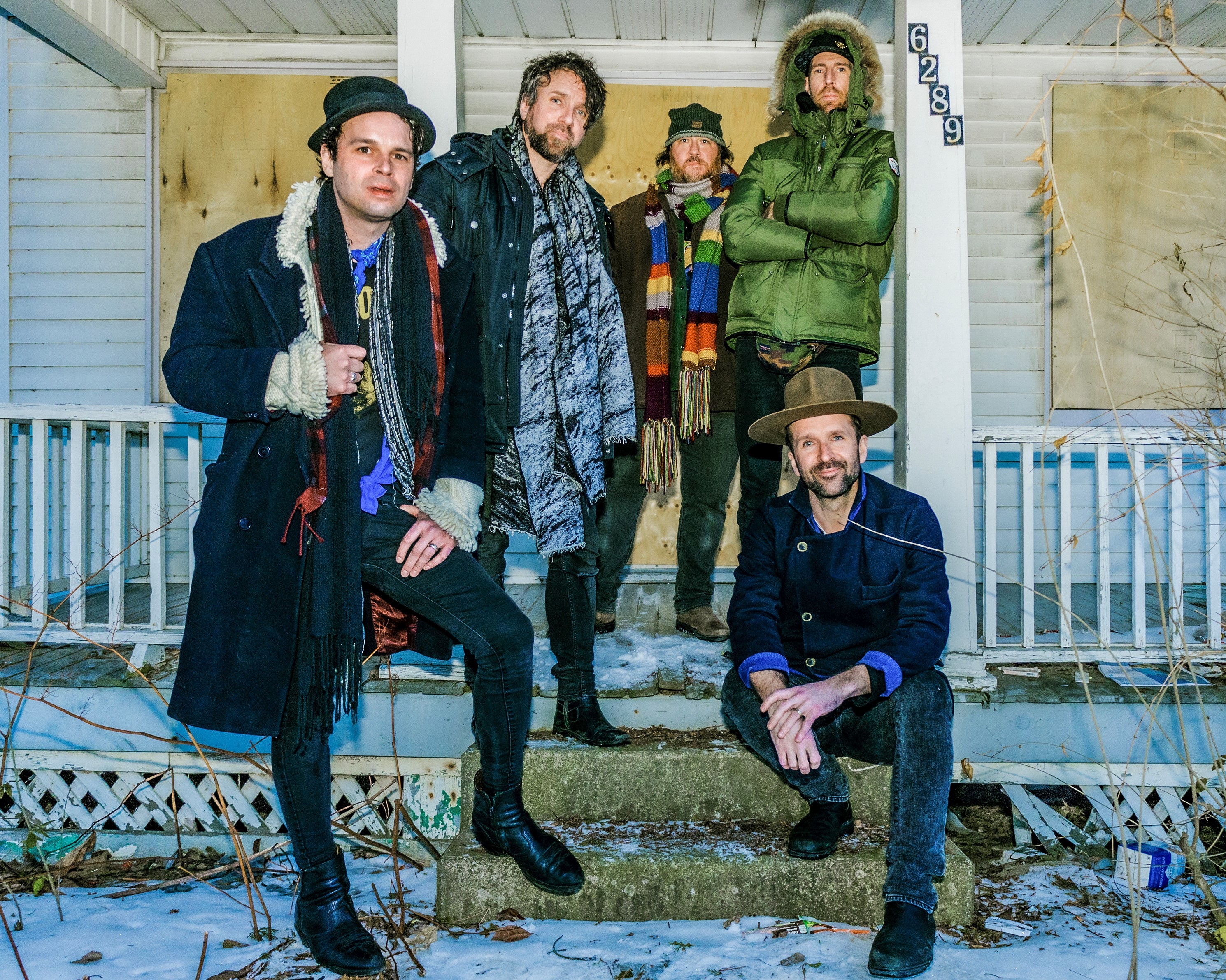 A photo of the Trews standing in front of a house