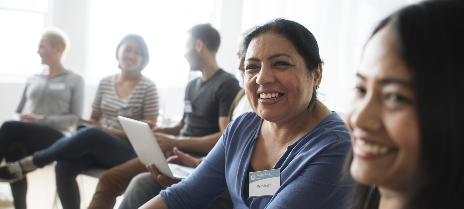 woman smiling at a community meeting